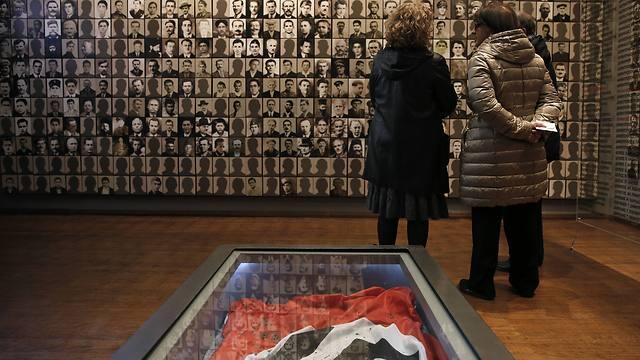 Visitors look at portraits of victims at the Holocaust Museum in the town of Kalavryta, western Greece (Photo: AP) (Photo: AP) Visitors look at portraits of victims at the Holocaust Museum in the town of Kalavryta, western Greece (Photo: AP)