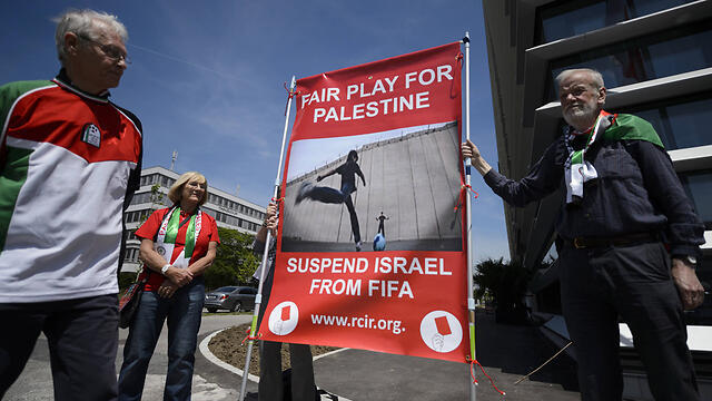 Protesters in Zurich call for Israel's suspension from FIFA. (Photo: AFP)