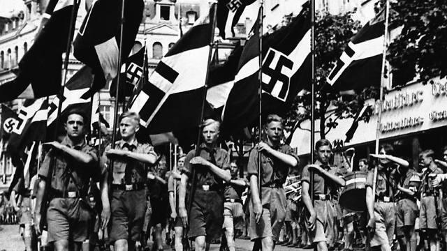 In this Feb. 24, 1936 file photo, a group of boys march beneath Nazi standards in Berlin (Photo: AP) (AP) In this Feb. 24, 1936 file photo, a group of boys march beneath Nazi standards in Berlin (Photo: AP)