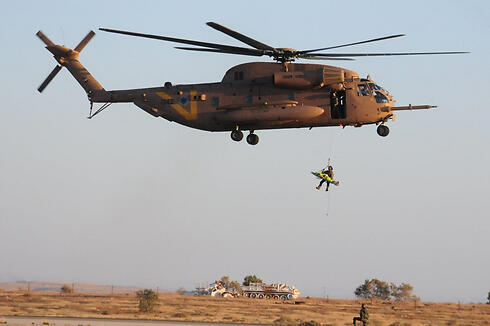 IDF soldier repelling from a Yasur helicopter