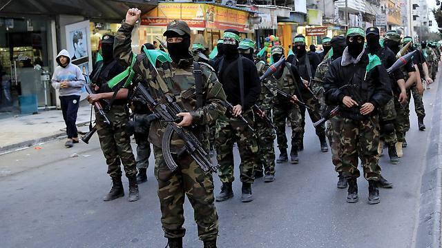 Members of Hamas's military wing parade in the street (Photo: AP)