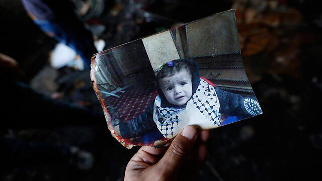 A photo of Ali in the burnt out home in Duma (Photo: EPA) (צילום: EPA) A photo of Ali in the burnt out home in Duma (Photo: EPA)