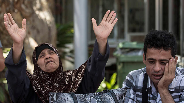 Allaan's mother and brother await news from the court (Photo: AP)