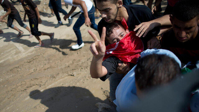 An injured Palestinian rioter (Photo: AP)
