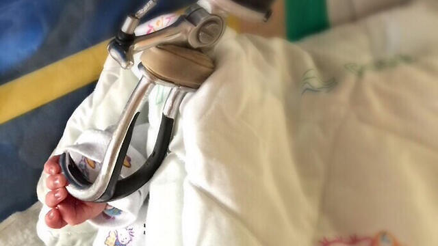 Shilon's daughter, grabbing his prosthetic hand.