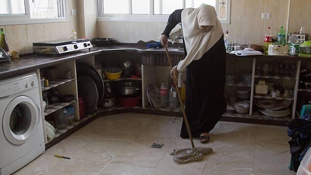 Um Alabed al-Zaza mops her new kitchen in the family's house (Photo: Associated Press)