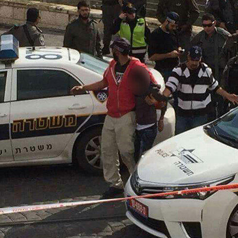 One of the attackers being arrested at Pisgat Ze'ev