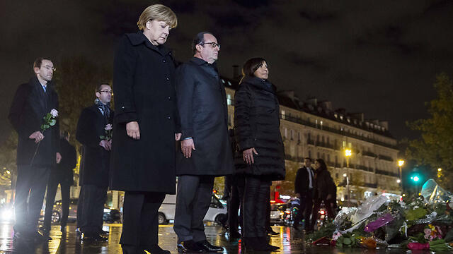 French President Francois Hollande and German Chancellor Angela Merkel honor terror victims in Paris. Europe must wake up and acknowledge that a religious war is brewing between radical Islam and the civilized, democratic and free Western world which includes Israel (Photo: AFP) (צילום: AFP) French President Francois Hollande and German Chancellor Angela Merkel honor terror victims in Paris. Europe must wake up and acknowledge that a religious war is brewing between radical Islam and the civilized, democratic and free Western world which includes Israel (Photo: AFP)