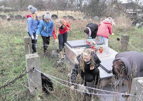 Polish students tending to the Jewish cemetery in Radomskonullnull Polish students tending to the Jewish cemetery in Radomsko