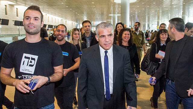 Lapid making his way through Ben Gurion Airport on Tuesday morning (Photo: Ido Erez)