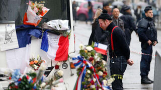 A man pays tribute outside the Bataclan concert hall in Paris following the Nov. 13, 2015, terrorist attacks 
