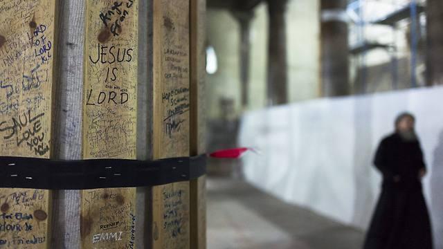A Russian Orthodox priest passes in front of a large column protected with wood in the central nave of the Church of the Nativity (Photo: EPA) (EPA) A Russian Orthodox priest passes in front of a large column protected with wood in the central nave of the Church of the Nativity (Photo: EPA)