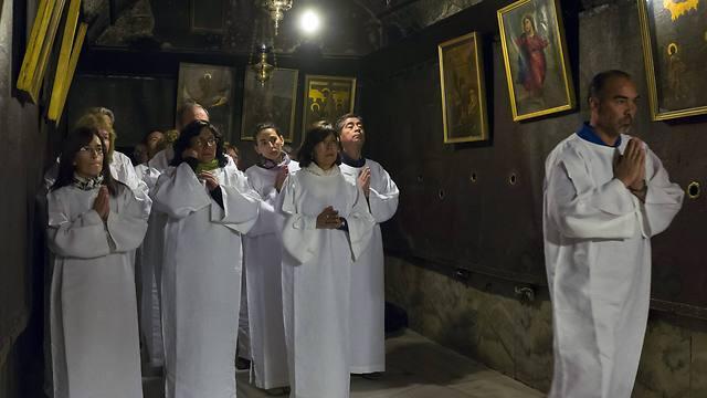 Christian pilgrims from Argentina wearing white robes gather for a mass amid prayers and songs in the 'Grotto' of the Church of the Nativity (Photo: EPA) (EPA) Christian pilgrims from Argentina wearing white robes gather for a mass amid prayers and songs in the 'Grotto' of the Church of the Nativity (Photo: EPA)