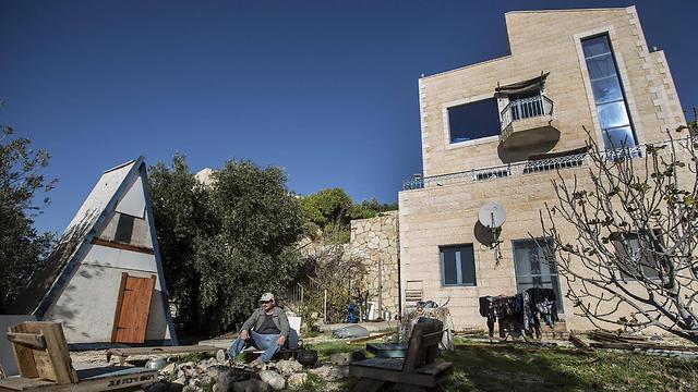 Moshe Gordon in front of his guesthouse in the West Bank (Photo: AP)