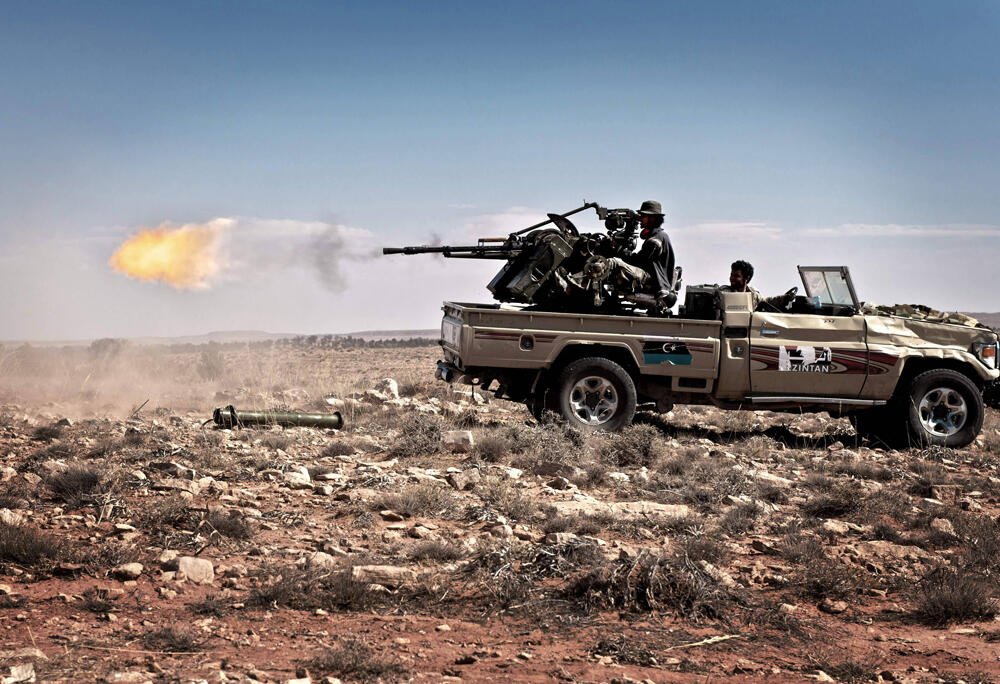 Libyan rebel fighters fire on forces loyal to Muammar Gaddafi during the civil war on June 15, 2011 