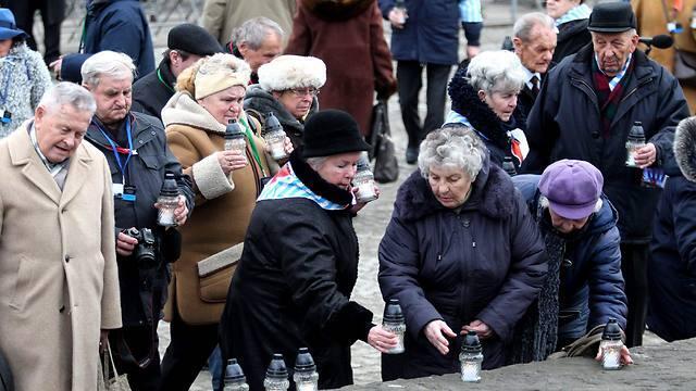 Former prisoners light candles at the International Monument to the Victims of Fascism at the former Nazi concentration and extermination camp KL Auschwitz II-Birkenau (Photo: EPA) (EPA) Former prisoners light candles at the International Monument to the Victims of Fascism at the former Nazi concentration and extermination camp KL Auschwitz II-Birkenau (Photo: EPA)