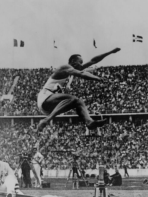 Jesse Owens competes in the long jump 