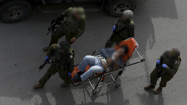 Al-Rajabi evacuated to hospital after he was stabbed (Photo: Reuters) (צילום: רויטרס) Al-Rajabi evacuated to hospital after he was stabbed (Photo: Reuters)