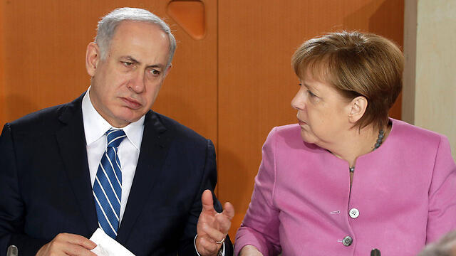 Netanyahu and Merkel meet in Berlin (File photo: AFP)