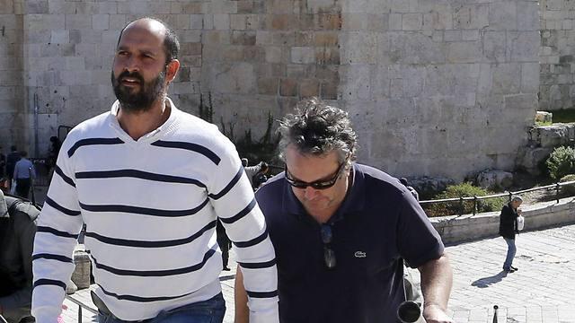 Washington Post reporters William Booth and Sufian Taha being escorted to a police station near Damascus Gate (Photo:Reuters)