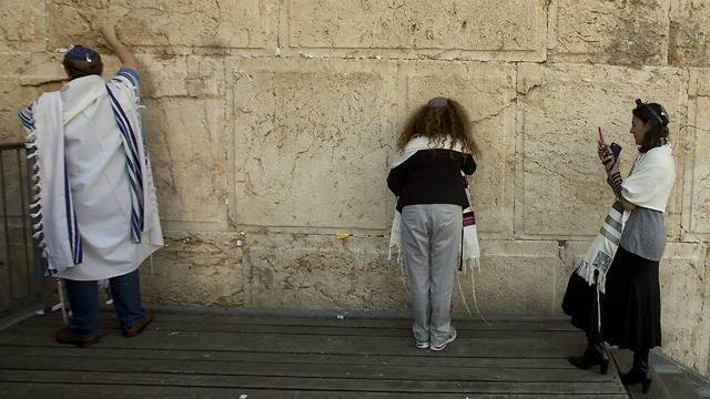 Reform Rabbi Nicole Greninger, right, takes a picture of other American and Israeli Reform rabbis as they pray in the Western Wall (Associated Press) Reform Rabbi Nicole Greninger, right, takes a picture of other American and Israeli Reform rabbis as they pray in the Western Wall