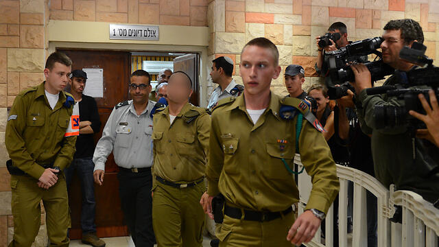 Court room with suspected soldier being led by military police (Photo: Avi Rokach)