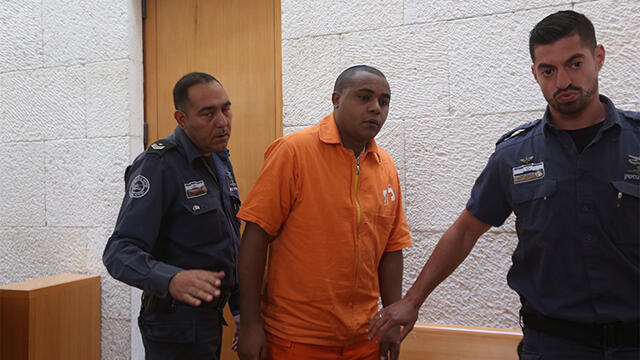 Yonatan Heilo (center), who killed the man who raped him, will be ineligible for a pardon based on the new agreement (צילום: גיל יוחנן ) Yonatan Heilo (center), who killed the man who raped him, will be ineligible for a pardon based on the new agreement