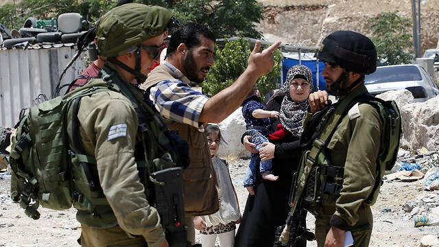 IDF soldiers in Yatta, the village the terrorists are from (Photo: EPA)