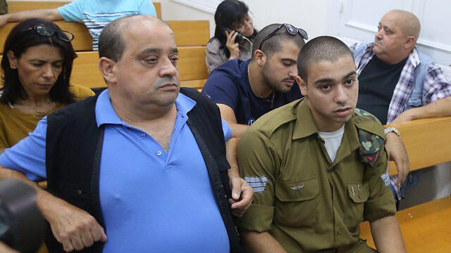 Sgt. Elor Azaria, right, in court with his father (Photo: Motti Kimchi)