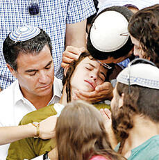 Pedaya Mark sits on lap of cousin Yossi Cohen during the funeral of his father, killed in a terror attack; Pedaya fell in Gaza in 2023 Pedaya Mark sits on lap of cousin Yossi Cohen during the funeral of his father, killed in a terror attack; Pedaya fell in Gaza in 2023