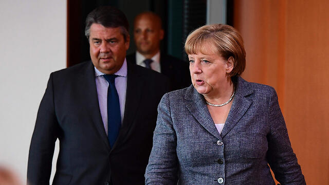 German Chancellor Merkel with Foreign Minister Gabriel, who put her in a catch-22 situation (Photo: AFP) (צילום: AFP) German Chancellor Merkel with Foreign Minister Gabriel, who put her in a catch-22 situation (Photo: AFP)