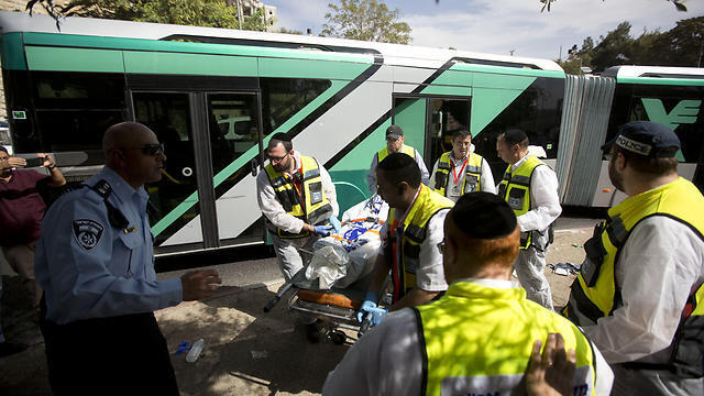 In this Tuesday, Oct. 13, 2015 file photo Israeli ZAKA emergency response members carry the body of an Israeli at the scene of a shooting attack in Jerusalem (Photo: AP) (Photo: AP) In this Tuesday, Oct. 13, 2015 file photo Israeli ZAKA emergency response members carry the body of an Israeli at the scene of a shooting attack in Jerusalem (Photo: AP)