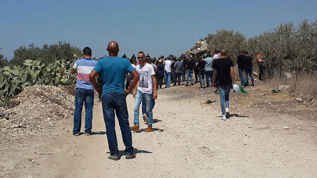 Arab residents blck the road to Melhem's housenullnull Arab residents blck the road to Melhem's house