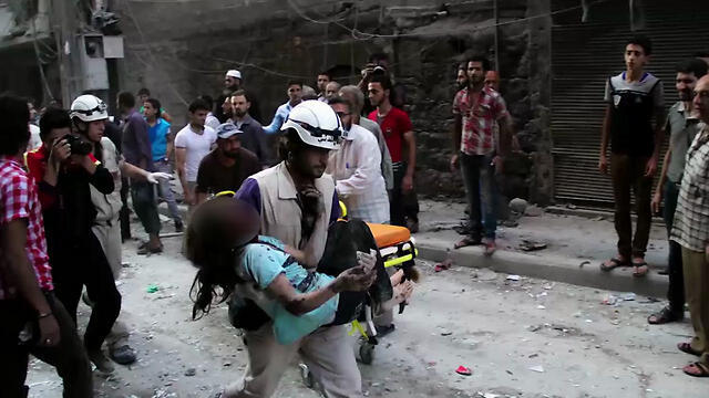 White Helmets member rescues a child