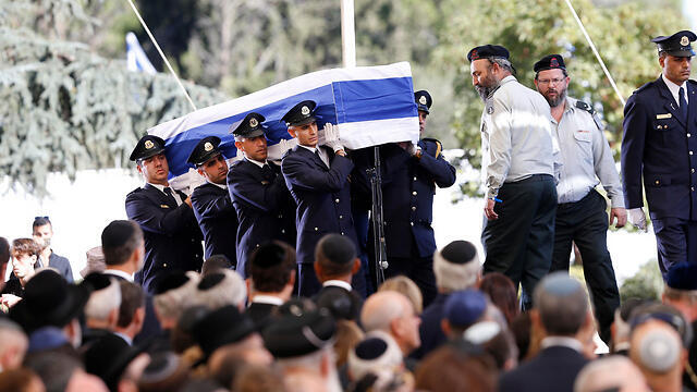 Peres's casket being carried (Photo: AP)