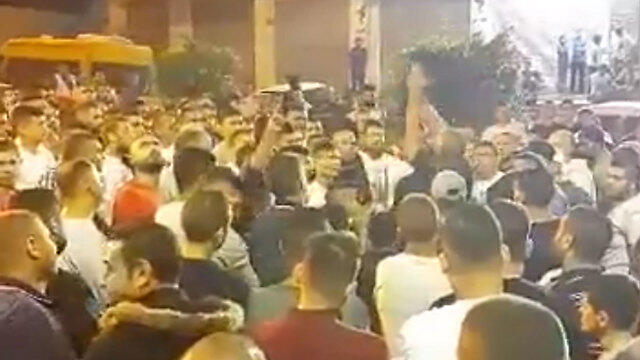 Celebrations outside the terrorist's home in the Village of al-Ram.
