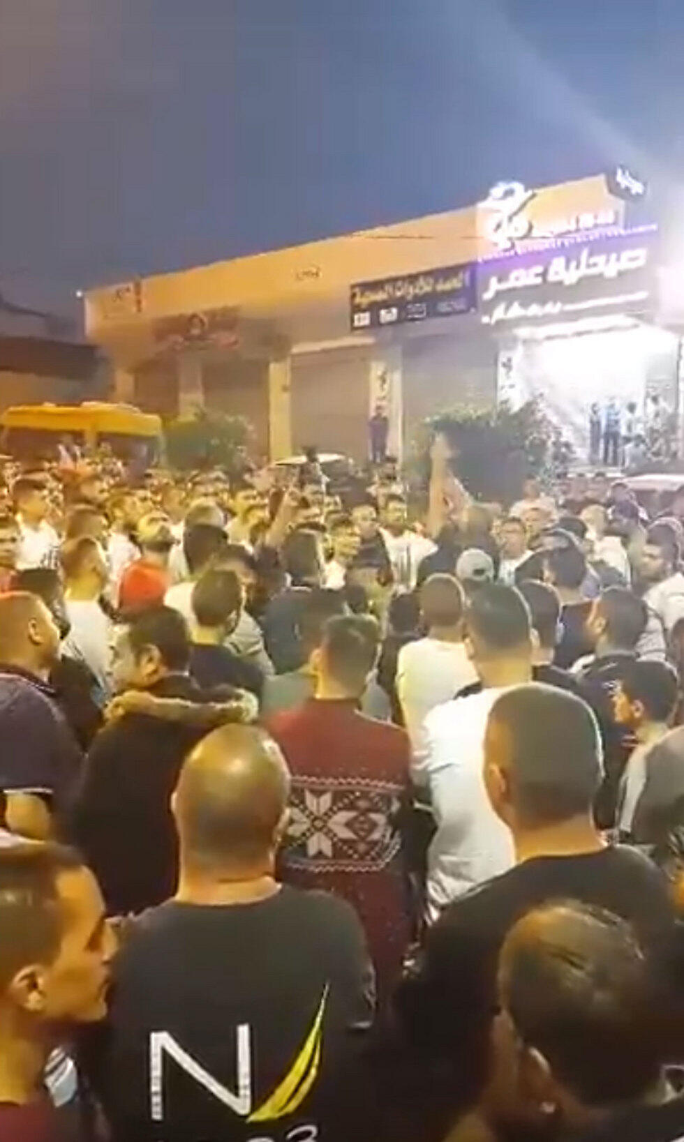 Celebrations outside the terrorist's family's home in the village of al-Ram