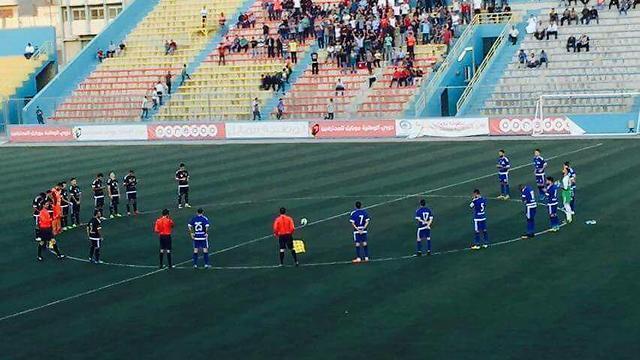 Players observing a moment of silence for the terroristnullnull Players observing a moment of silence for the terrorist
