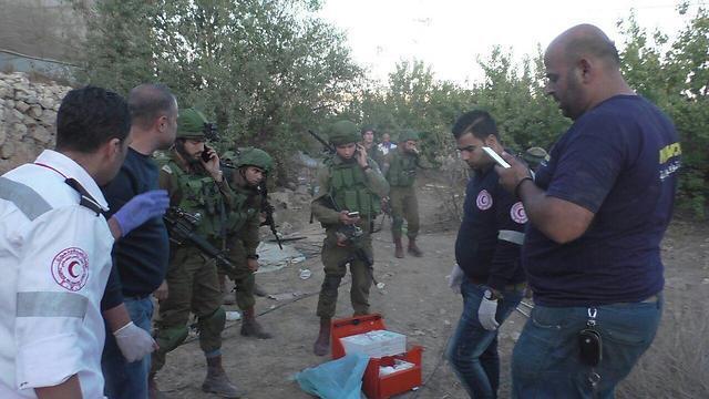 Israeli security forces and medical personnel surround the body of the Palestinian killed by IDF firenullnull Israeli security forces and medical personnel surround the body of the Palestinian killed by IDF fire