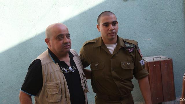 Sgt. Elor Azaria with his father Charlie in court (Photo: Motti Kimchi)