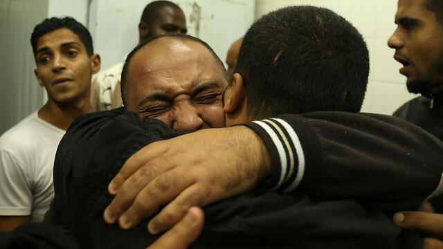 Relatives react after seeing the body of Mohammed Abu Saada (Photo: AFP)