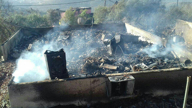 A burnt down house in the settlement of Halamish (Photo: Judea and Samaria Fire Department Spokesperson's Unit)