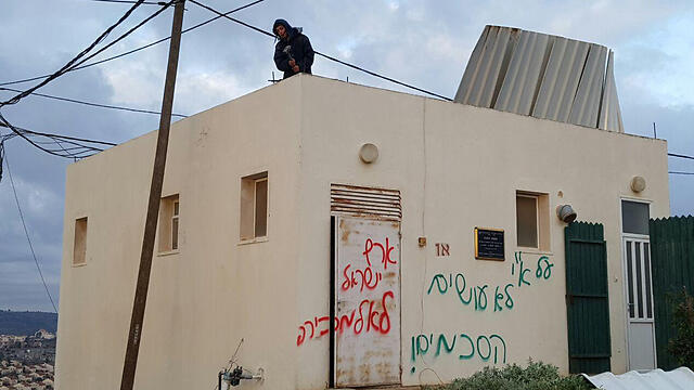 Graffiti in Amona declaring: 'You don't make agreements on the Land of Israel; the Land of Israel is not for sale' (Photo: Ido Erez)