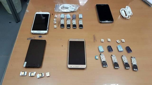 Some of the phones Ghattas was caught smuggling into prison.