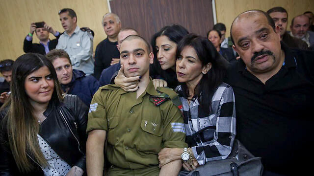 Azaria at court with his girlfriend to his right and his parents to his left (Photo: Flash90)