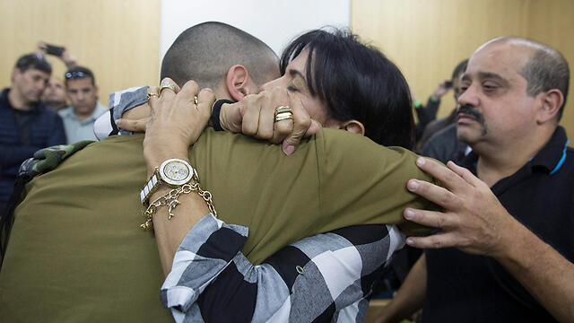 Azaria being embraced by his mother at court (Photo: EPA)