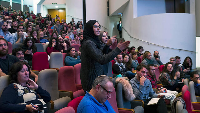 An Arab student disrupts Syrian speakers at peace conference (Photo: EPA) (צילום: EPA) An Arab student disrupts Syrian speakers at peace conference (Photo: EPA)