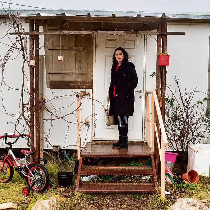 Yifat Erlich at the entrance to the caravan she used to live in. ‘Pioneers don’t break down. They always get up and climb the mountain again’ (Photo: Yoav Dudkevitch)nullnull Yifat Erlich at the entrance to the caravan she used to live in. ‘Pioneers don’t break down. They always get up and climb the mountain again’ (Photo: Yoav Dudkevitch)