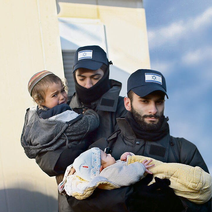 Baby Moshe and his brother, 4-year-old Yossef held by police officersnullnull Baby Moshe and his brother, 4-year-old Yossef held by police officers
