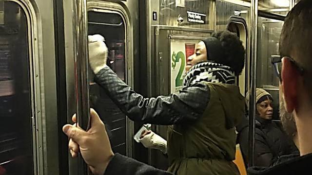 Fellow passengers help wipe away the hate (Photo: Gregory Locke)